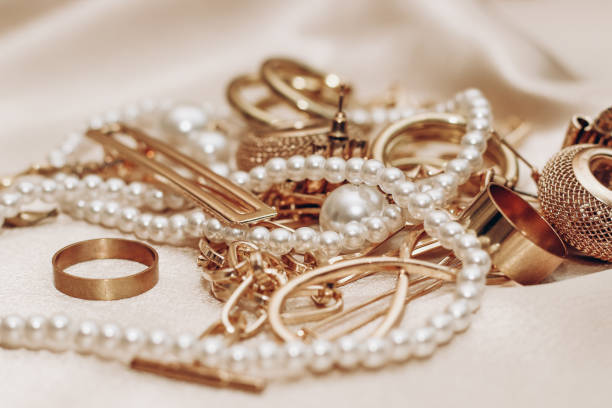 Women's jewelry, gold chain, trendy jewelry on a silk background.