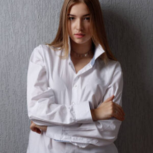 Charming handsome. young pretty woman in white shirt posing.